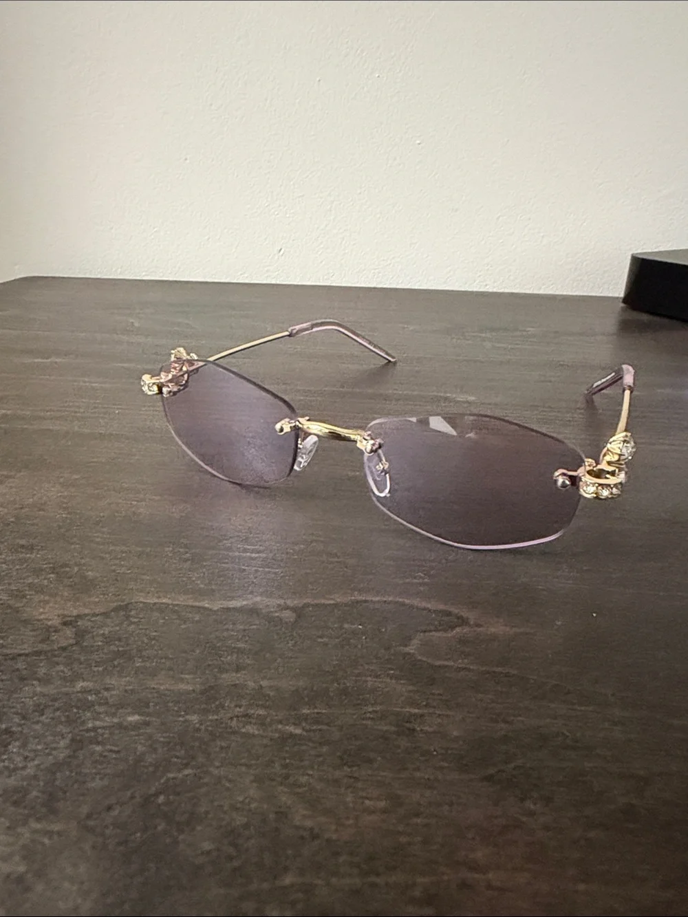 Elegant Rimless Women's Sunglasses with Gold Accents - Purple Lenses